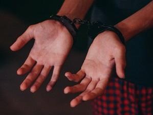 image of handcuffs on wrists