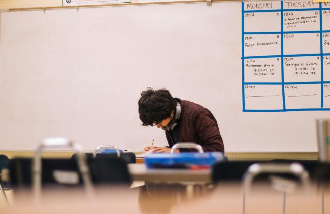 Student sitting at a desk in a classroom